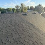 Completed new roof with new vents and ridge line, surrounding neighborhood in the background, Bend, Oregon