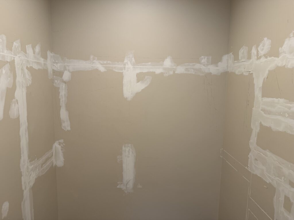Fresh drywall mud applied over patched seams during repair, Sunriver, Oregon