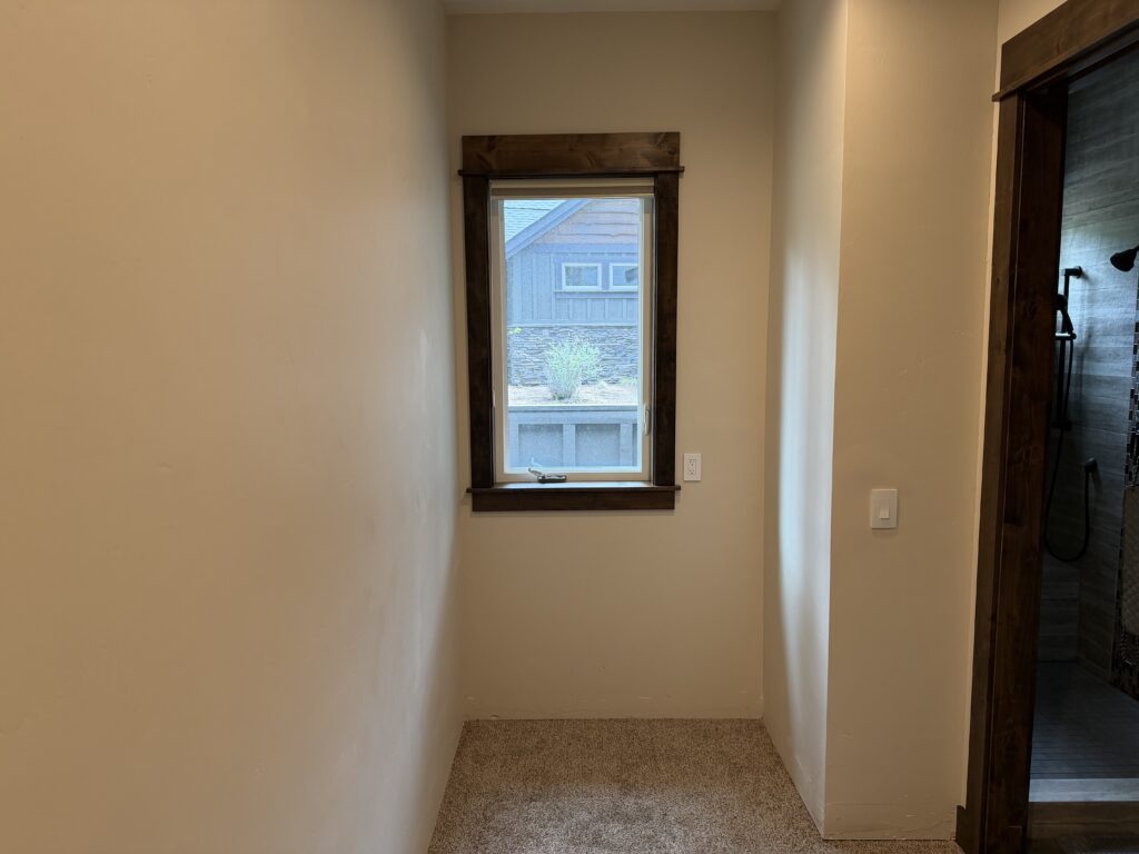 Completed primary bedroom with closet doorway after drywall repair and paint, Sunriver, Oregon