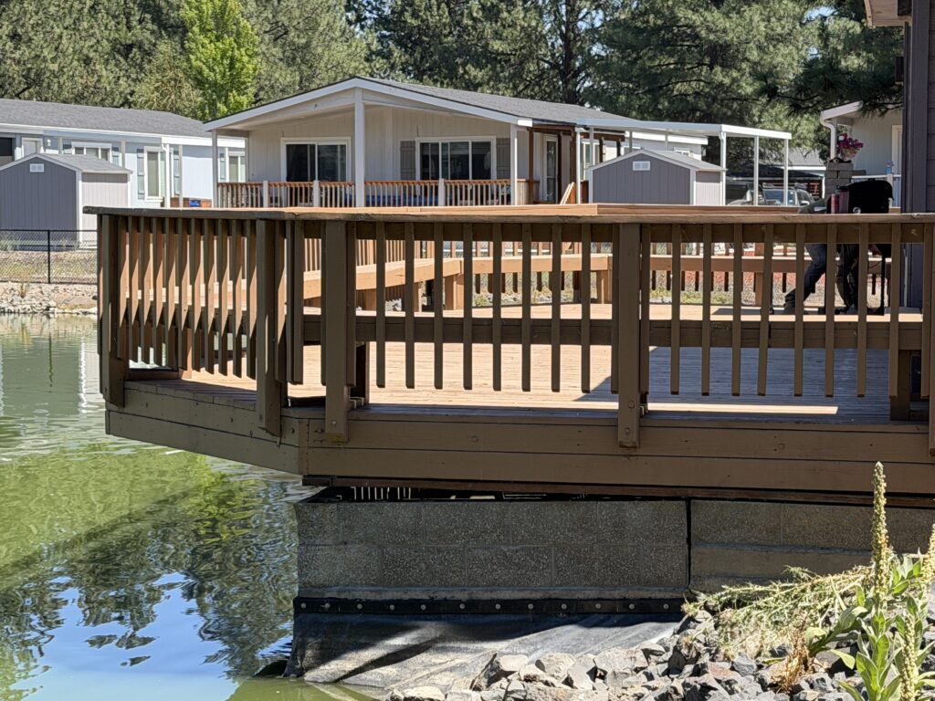 Angled view of the completed community pondside deck after leveling and support repair