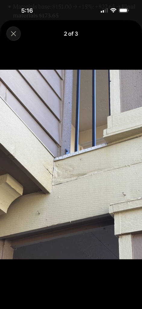 Corner trim board prepped and masked for exterior repair, showing new wood joint before painting